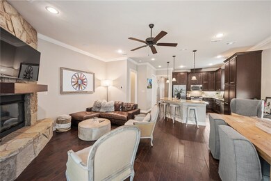 Living area with a ceiling fan, a fireplace, dark