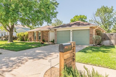 Ranch-style home featuring a front lawn and a garage