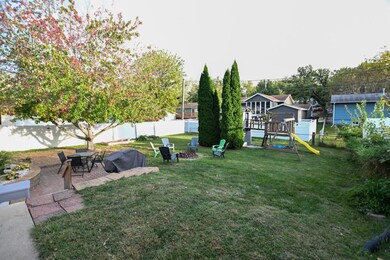Backyard with patio, fire pit and kid's play set