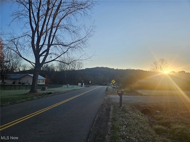 View of asphalt street featuring traffic signs and a mountain view