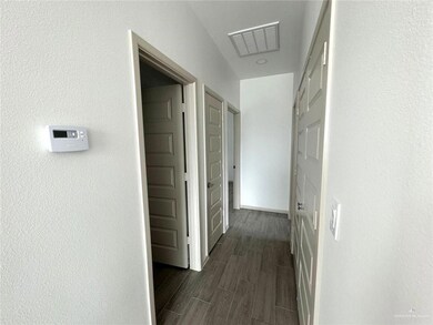 Hall with visible vents, baseboards, and wood finish floors