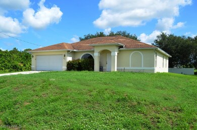 View of front of house with stucco siding, a garag