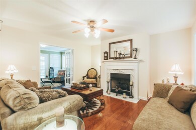 The formal living room, flows from the front foyer, around to the Florida room & back out to the kitchen. All custom window blinds were installed by the owner and remain with the sale. 