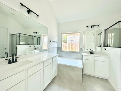 Full bathroom with vaulted ceiling, a shower stal
