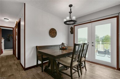 Wood floored dining area with a textured ceiling