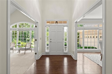 Dramatic front entry framed by oversized windows and abundant natural light.