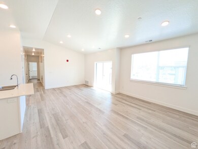 Living room featuring light wood-type flooring, recessed lighting, and a textured ceiling