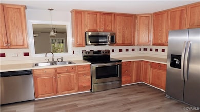 Kitchen with light countertops, stainless steel ap