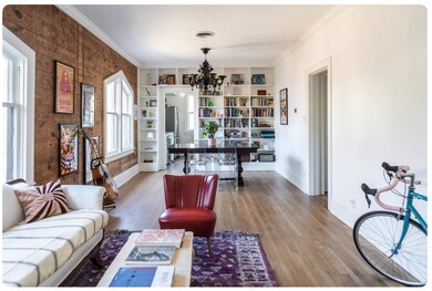 Living area with baseboards, a notable chandelier