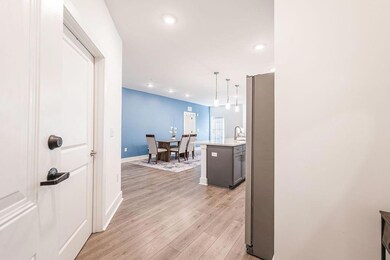 Hall featuring light wood finished floors, baseboa