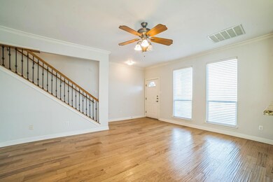 Foyer entrance featuring ceiling fan, wood finish