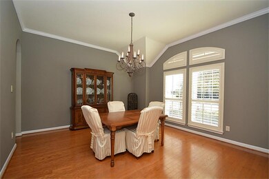Formal dining room w/crown molding, wood floors, and plantation shutters