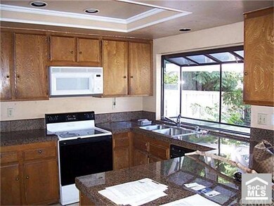 Spacious kitchen overlooks patio and is open to fa