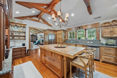 Kitchen with lofted ceiling with beams, butcher bl