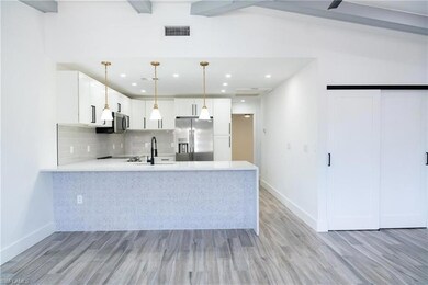 Kitchen with decorative backsplash, light countert