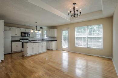 Kitchen offers ample counter space. Door leading o