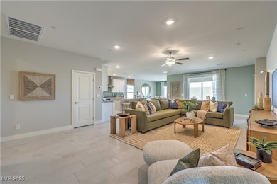 Living area featuring a ceiling fan, recessed ligh