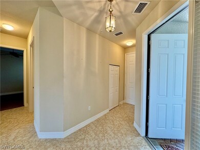 Hallway with light tile patterned flooring