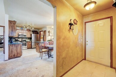 Entryway with a textured ceiling, light tile patte