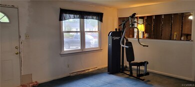 Workout room featuring carpet flooring and a baseb