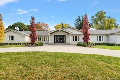 Ranch-style house with a front yard and stucco siding