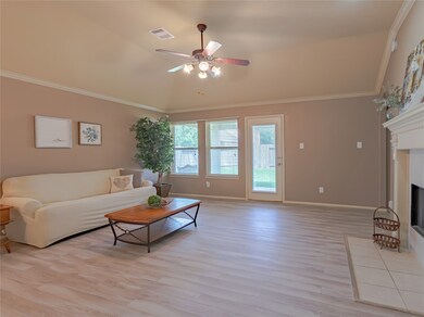 The living room also comes with three windows for a view into the backyard, tall ceilings, and a ceiling fan.