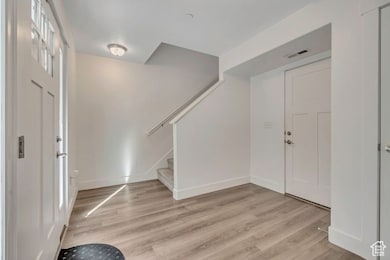 Entrance foyer featuring light wood finished floors and stairs