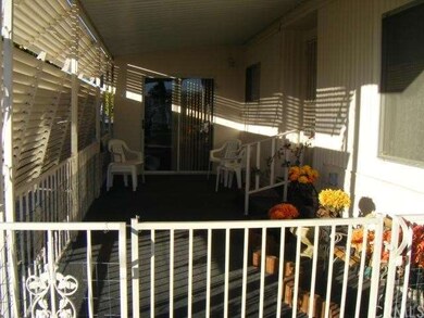 Front patio with hand rail to the front door.  Also sliding door access to room addition.