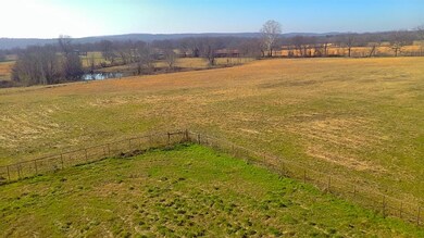 View of yard with a rural view and a water view