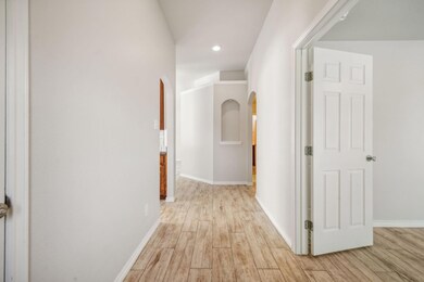 Hall with light hardwood / wood-style floors