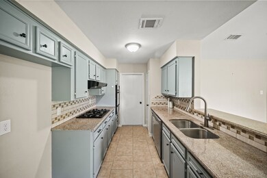 Kitchen with granite counters, gas stove, in wall