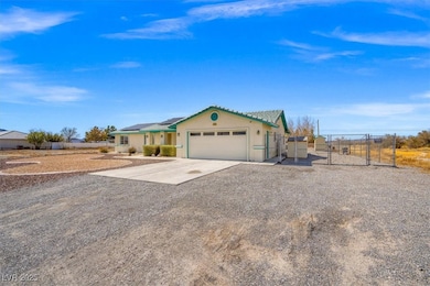 View of front of property with a gate, concrete dr