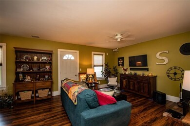 The large living room showcases stunning hardwood 