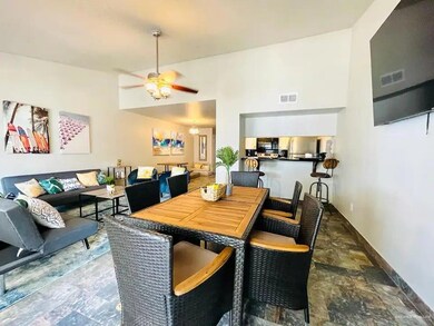 Tiled dining room with ceiling fan