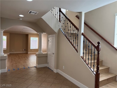 Staircase with decorative columns, arched walkways