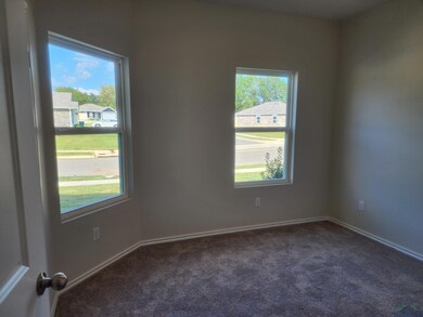 Unfurnished room with dark colored carpet