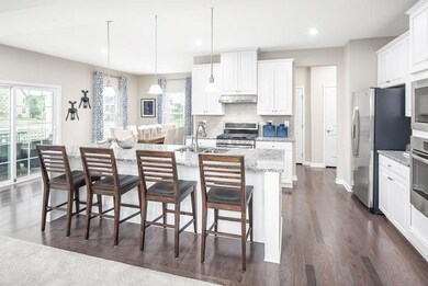 Spacious kitchen, complete with SS, energy star appliances, expansive kitchen island, and  *Photos of a current Model*