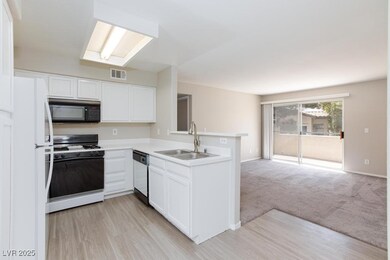 Kitchen featuring range with gas stovetop, black m