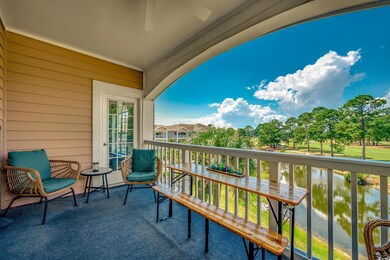 Balcony featuring a water view, a ceiling fan, and a sunroom