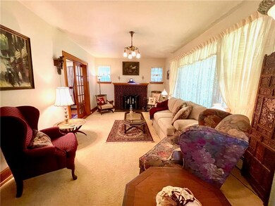 The living room has a fireplace and large picture