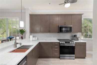 Kitchen with pendant lighting, sink, appliances wi