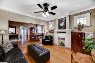 Entering living room from front door, new fan & lighting. Faux fireplace.