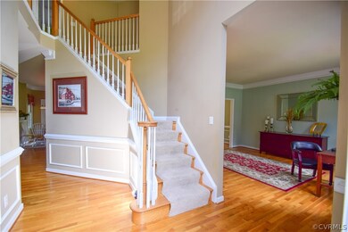 Dramatic two-story foyer with turning staircase.