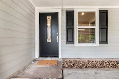The entrance of the home features a stylish wooden