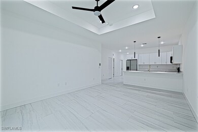 Unfurnished living room featuring baseboards, rece