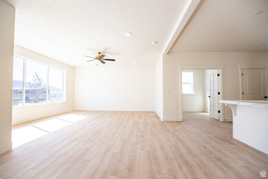 Great room with spectacular windowing, with adjoining dining and kitchen spaces.