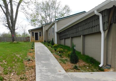 Concrete sidewalk leading to entrance Foyer.