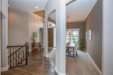 View of formal dining, entry and stair case leadin