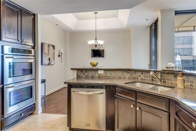 Kitchen with decorative backsplash, dark stone cou