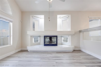 Unfurnished living room featuring a tiled fireplac